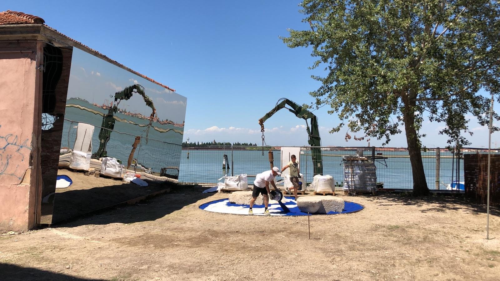 Barche e laguna riflessi su facciata specchiante